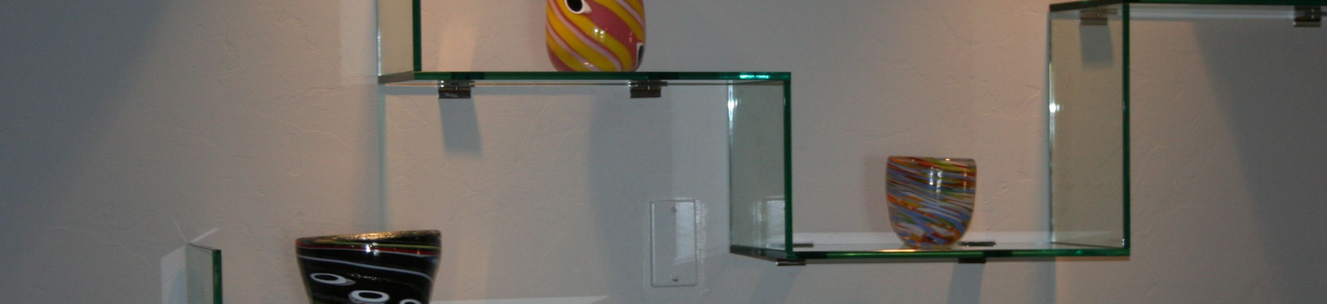 Stairstep glass shelves with pots and decorations