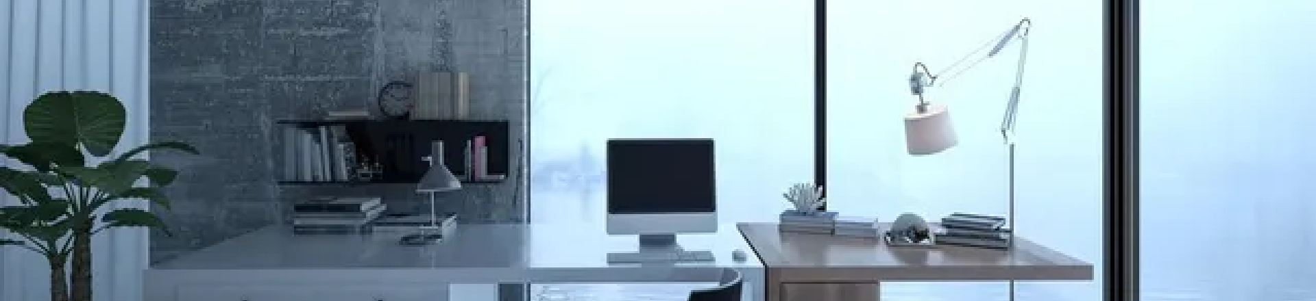 Desk with computer and other decor items in front of frosted windows