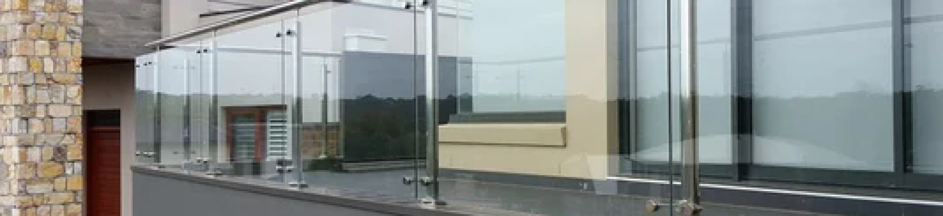 Glass paneled railing on an outdoor balcony