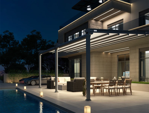 Modern home at night with a gazebo with glass canopy.