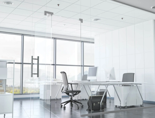 Stark white interior with glass walls and large windows