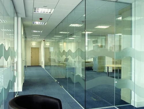 Hallway with glass partitions onlooking office space