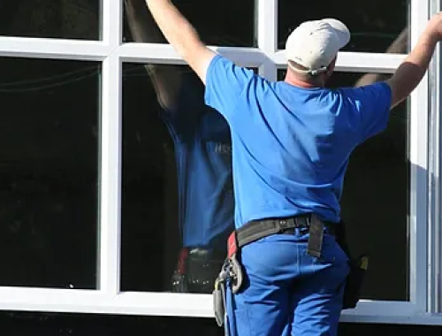 Man measuring window width