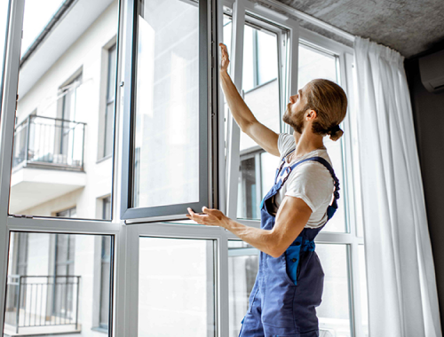 Worker installing a window