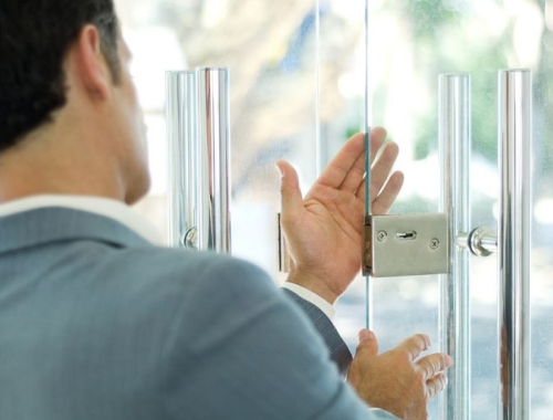 Man opening up glass doors