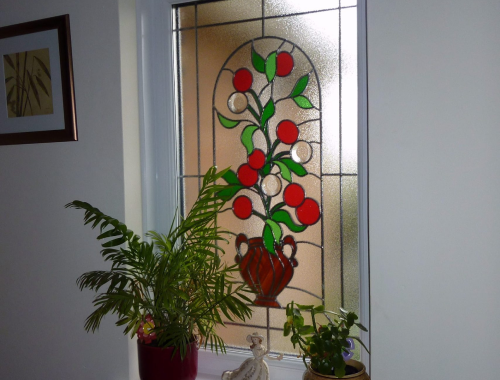 Custom stained glass depicting a fruiting plant